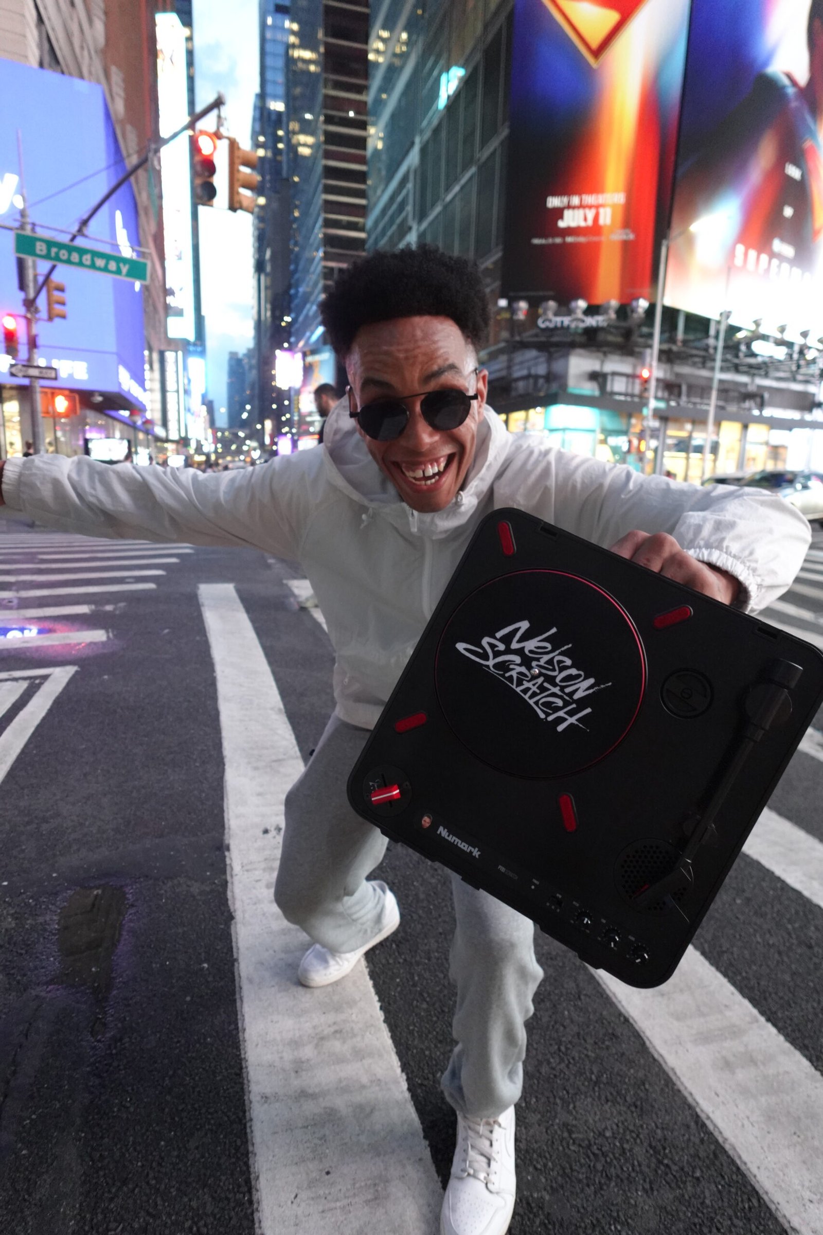 Nelson Scratch from Hug Bookings in Times Square with a Numark PT01 showing his logo